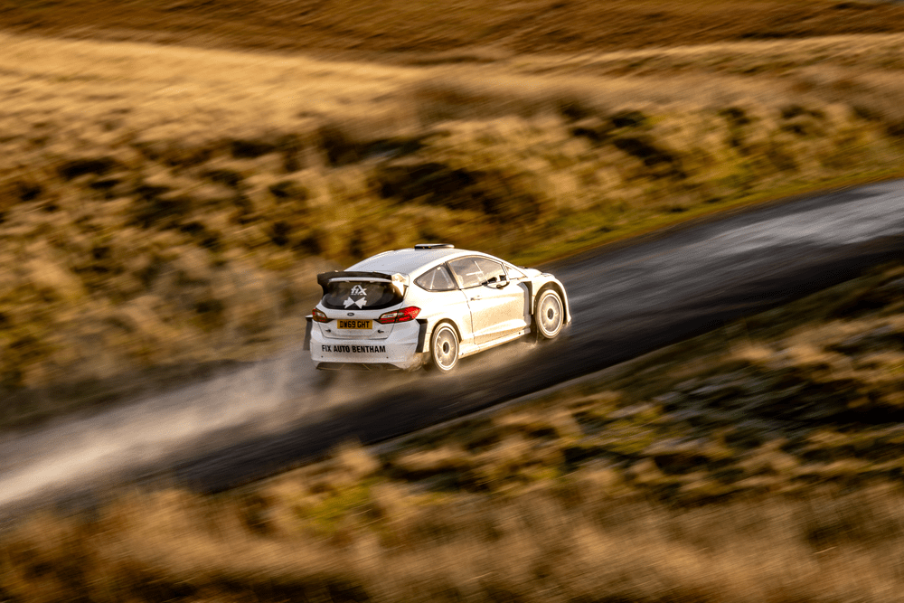 Fiesta Rally2 car driving fast with water trails coming from rear tyres